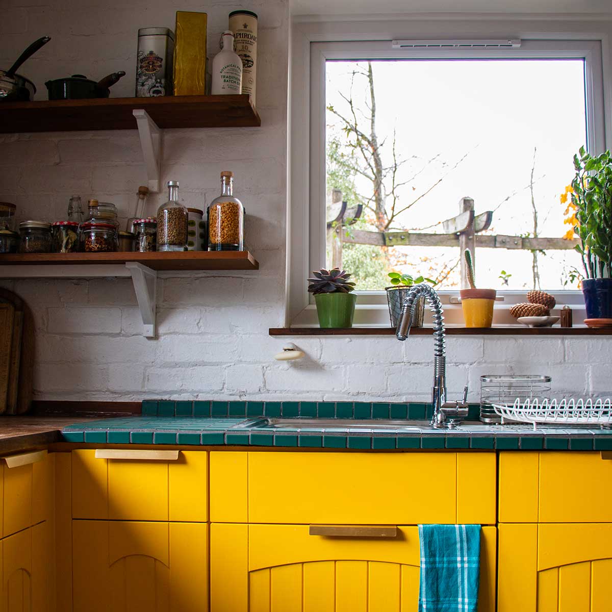 Photo of interior designed kitchen with bright yellow cupboard doors